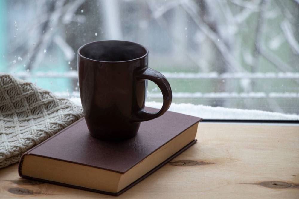 Große Tasse Tee auf einen Buch stehend